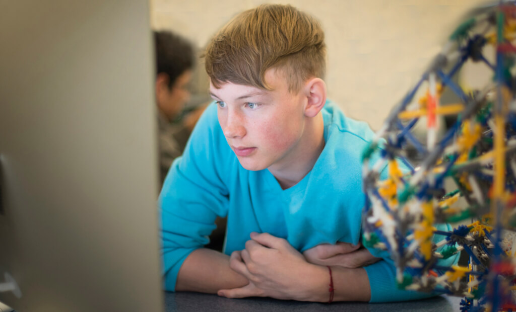 focused student looking at a monitor while at school